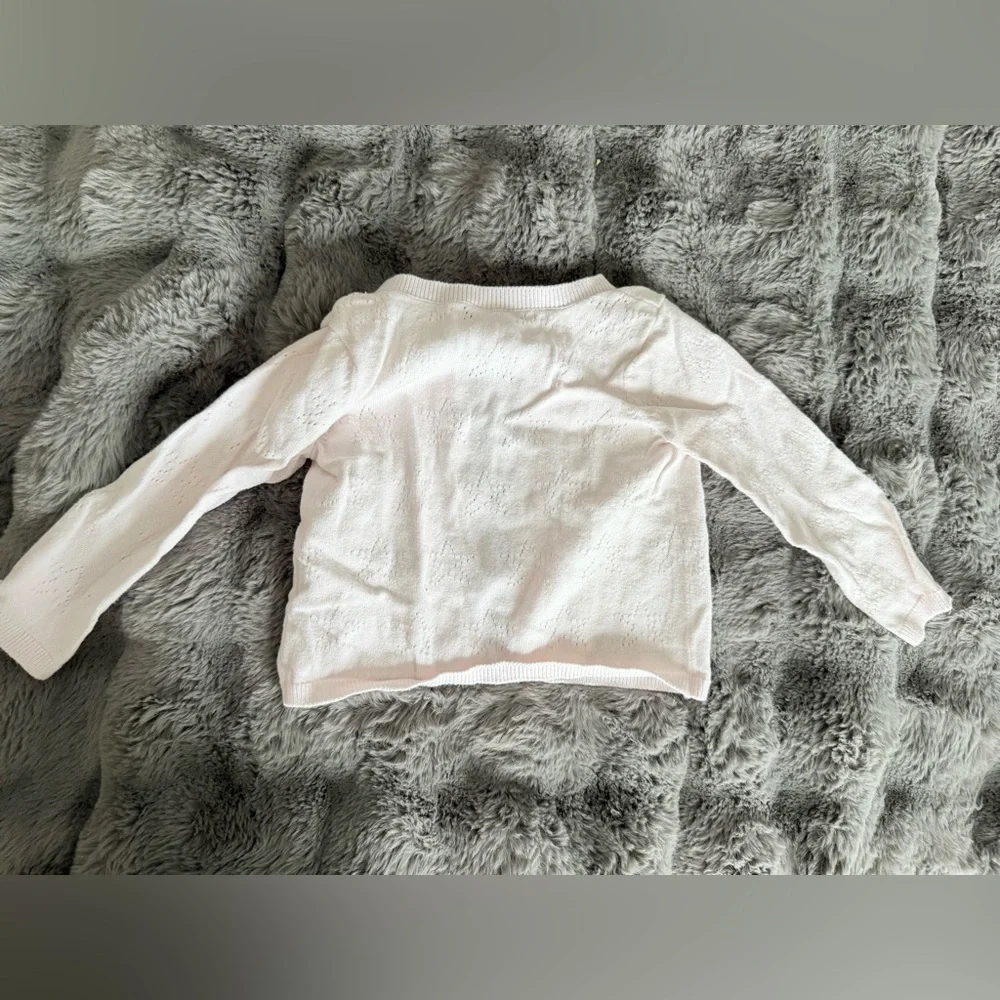 Light pink cardigan size 9-12M has a faint stain